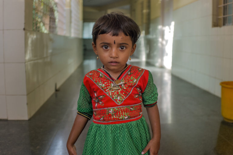 little girl in red and green