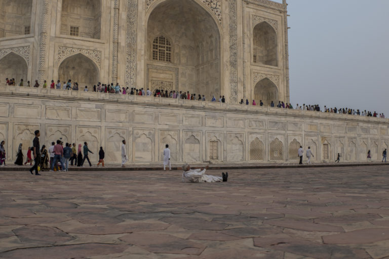 man on floor taj mahal