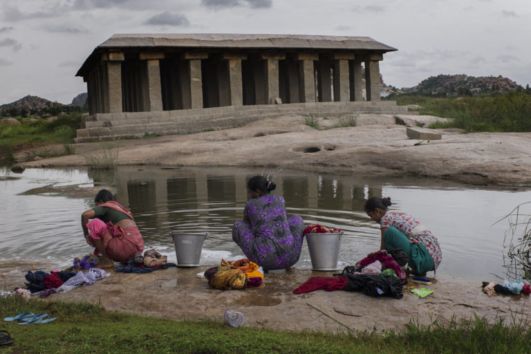 women doing laundry on river
