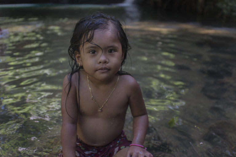 filipino little girl on waterfall